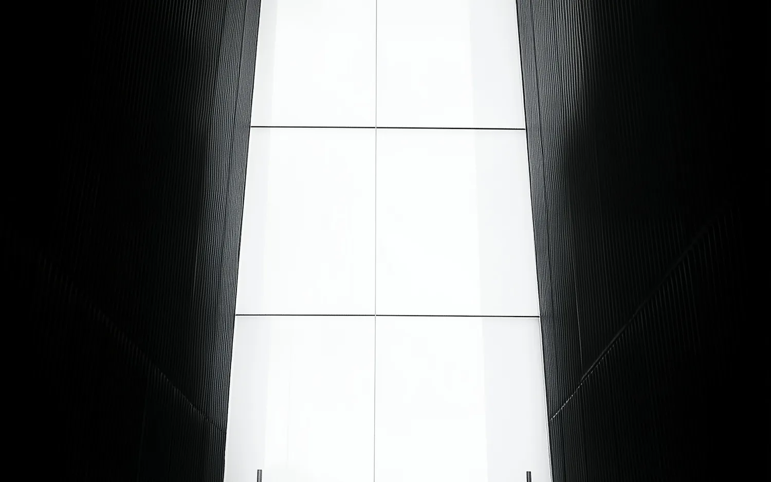 A concept study: a silhouette in a tall bright opening at the end of a dark corridor.